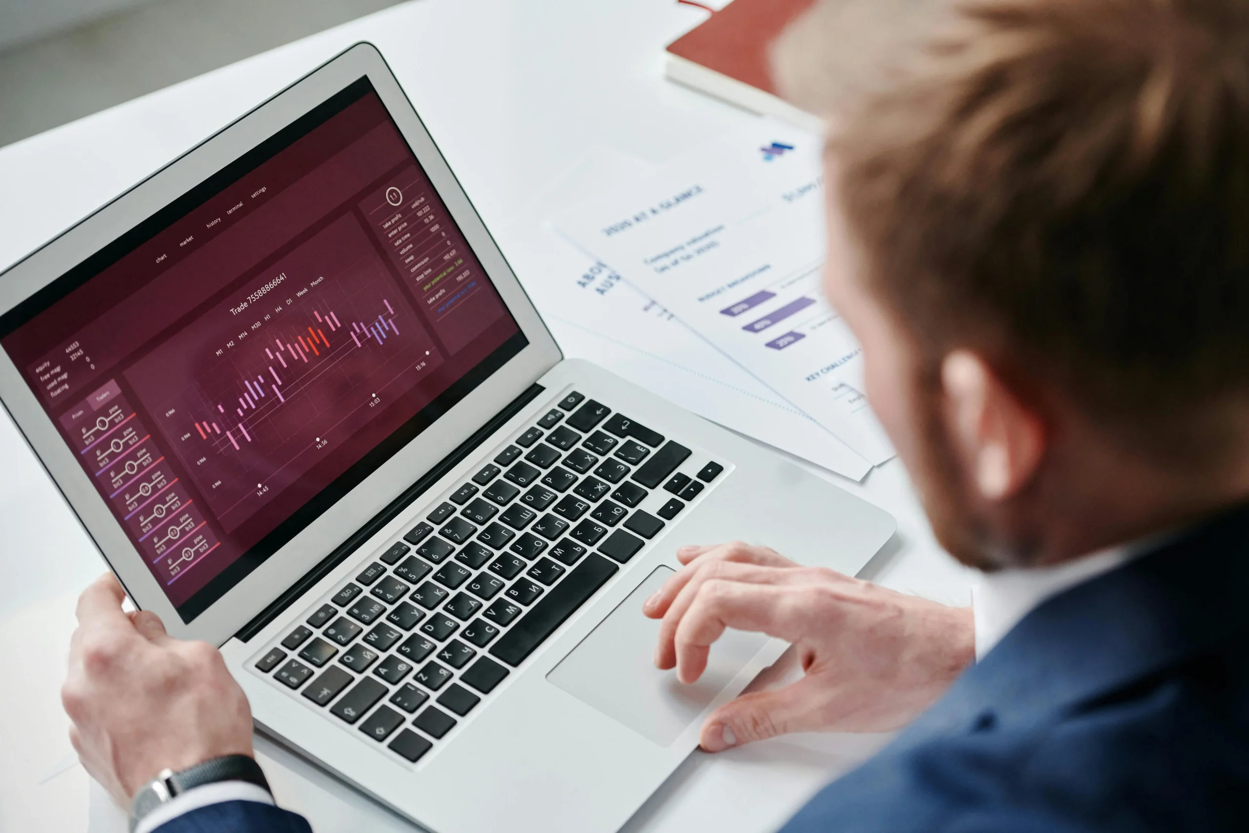 Businessman reviewing data analytics dashboard on laptop representing a client project status portal